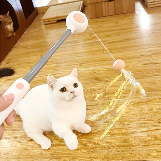 White cat playing with feather wand toy on wood floor