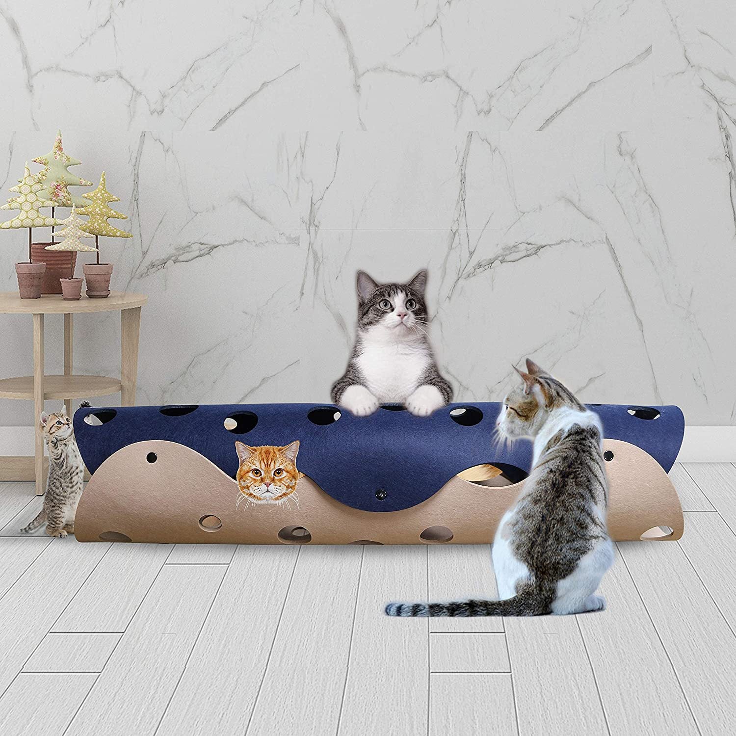 Cat sitting beside Hideaway Cat Tunnel in room setting